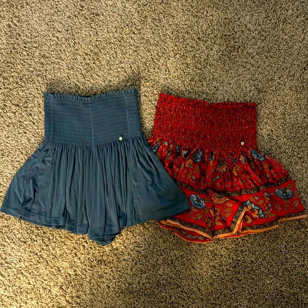 Two Natural Life XS skorts. One blue and one red floral skort.